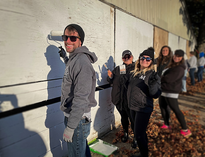 M1 Credit Union staff painting at the Free Fair for M1 Gives Back Day, engaging with the community through creativity and volunteerism